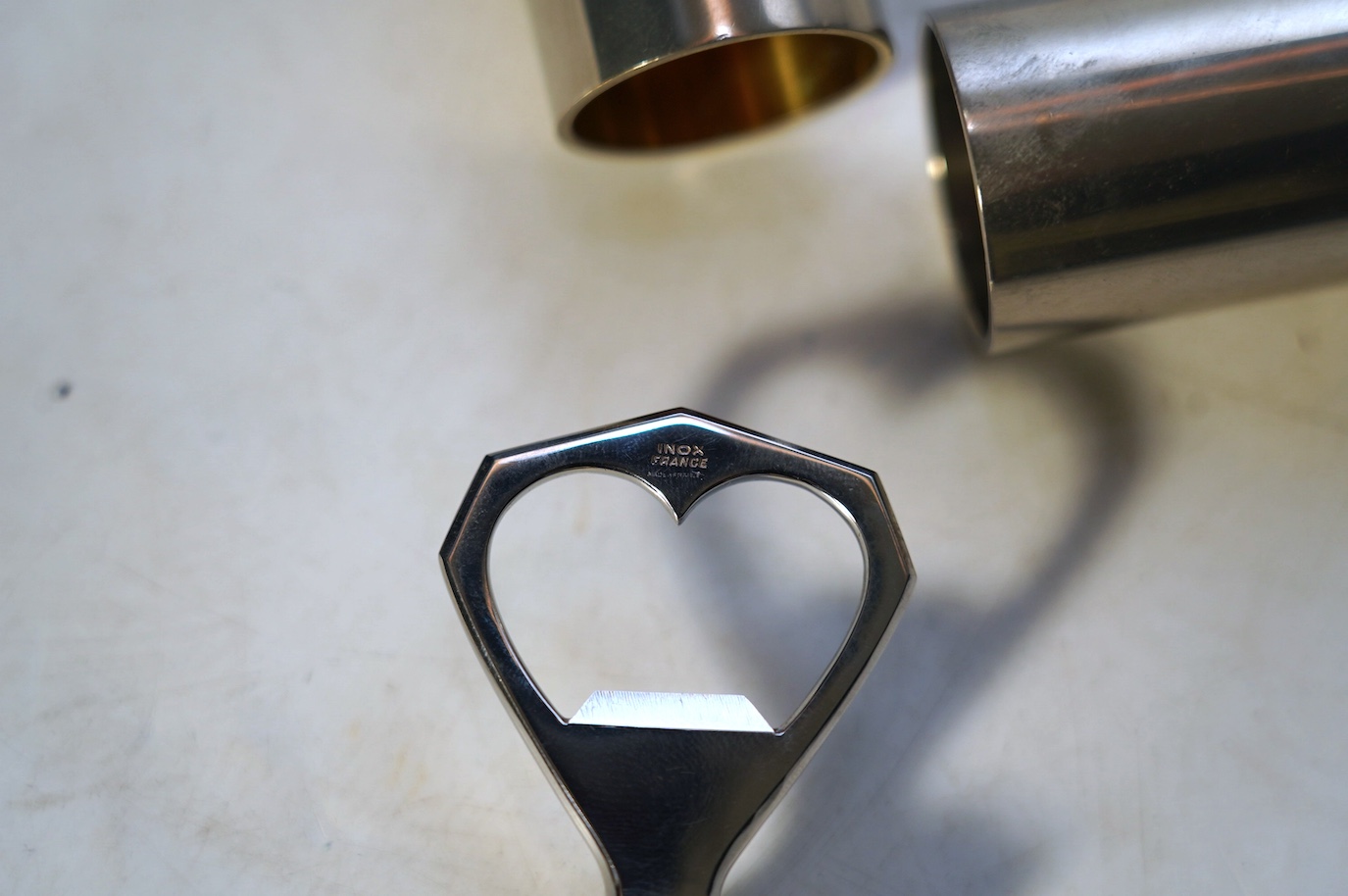 A pair of Hermes 'shotgun cartridge' handles and bottle opener